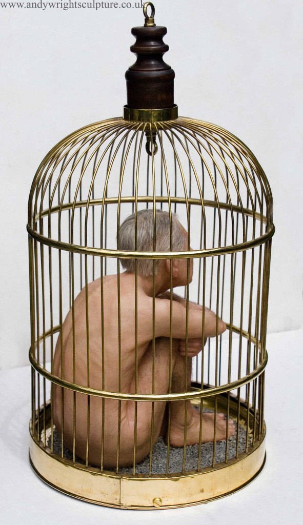 Nude man trapped in a cage miniature sculpture.